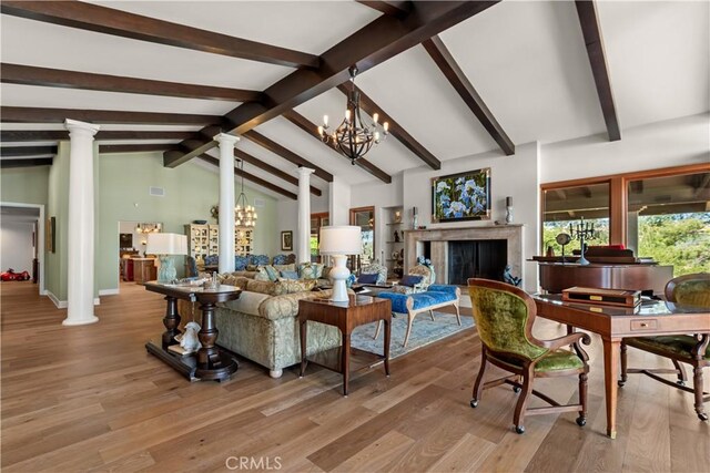 23815 Park Belmonte, Calabasas, CA 91302 - living area with decorative columns, a chandelier, a fireplace, and light wood-type flooring
