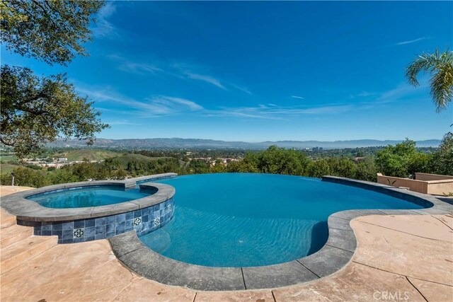 23815 Park Belmonte, Calabasas, CA 91302 - view of pool featuring a pool with connected hot tub and a mountain view