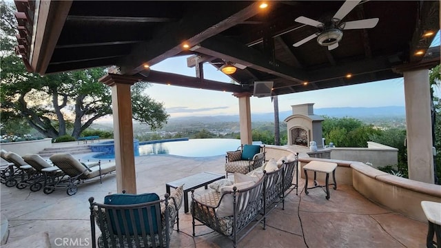 23815 Park Belmonte, Calabasas, CA 91302 - view of patio / terrace with an outdoor fireplace, a gazebo, ceiling fan, and an infinity pool