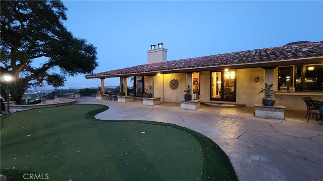 23815 Park Belmonte, Calabasas, CA 91302 - rear view of property with a putting area, a patio area, a chimney, and stucco siding