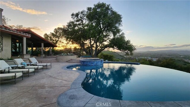 23815 Park Belmonte, Calabasas, CA 91302 - pool at dusk with a patio area and a pool with connected hot tub