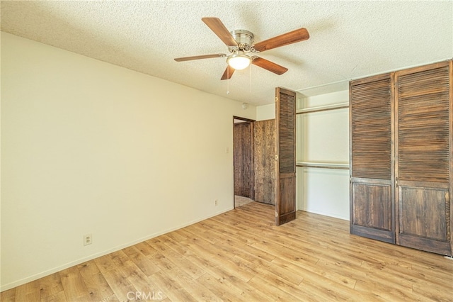43421 45th St W, Lancaster, CA 93536 - unfurnished bedroom featuring light wood-style flooring, a textured ceiling, a closet, a ceiling fan, and baseboards