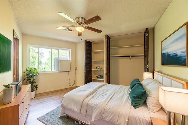 43421 45th St W, Lancaster, CA 93536 - bedroom with light wood-style flooring, a textured ceiling, ceiling fan, baseboards, and a closet