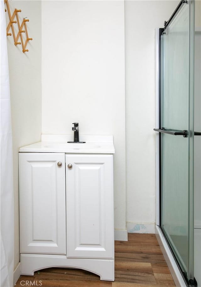 523 Lincoln Ave, Pasadena, CA 91103 - full bath featuring baseboards, wood finished floors, walk in shower, and a sink