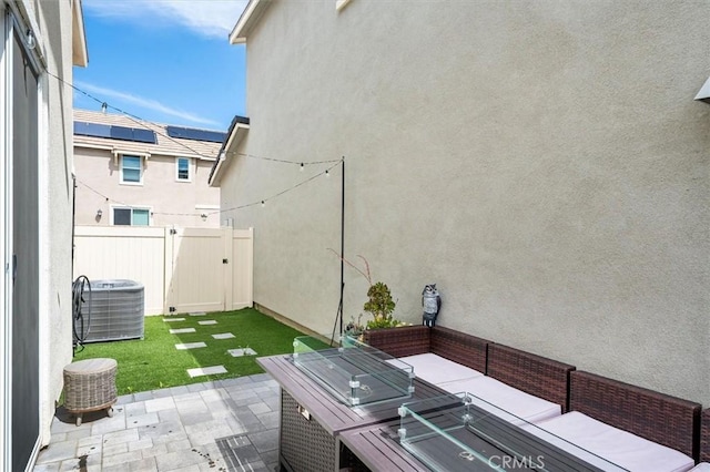 view of patio / terrace with outdoor lounge area, fence, and central AC unit