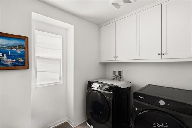laundry area with baseboards, cabinet space, visible vents, and independent washer and dryer