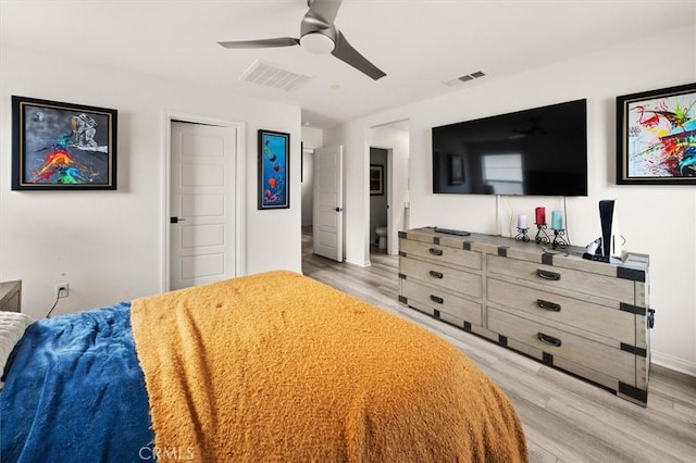bedroom with ceiling fan, visible vents, and light wood-style floors