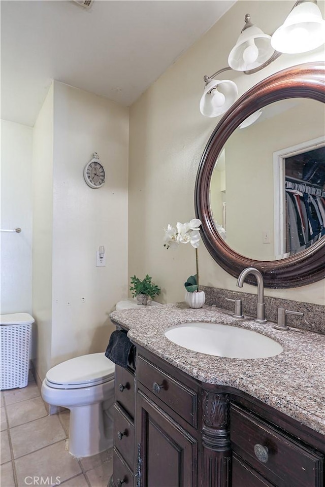 bathroom featuring tile patterned floors, toilet, and vanity