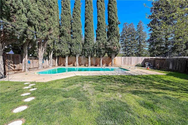 view of pool with a fenced backyard, a fenced in pool, a yard, and a patio