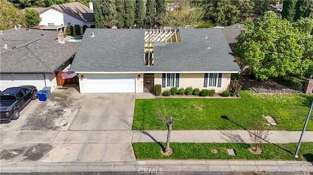 view of front of property with driveway, a garage, a front lawn, and roof with shingles