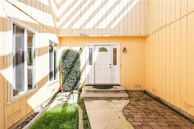 view of exterior entry with visible vents