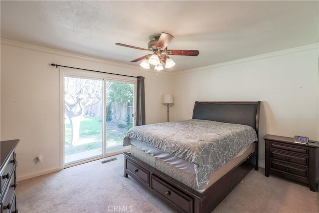 bedroom featuring crown molding, visible vents, access to outside, and carpet