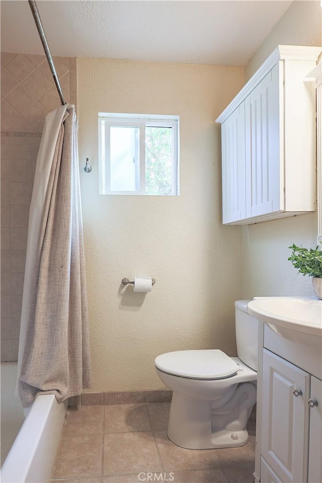 bathroom with shower / bath combination with curtain, toilet, vanity, and tile patterned floors
