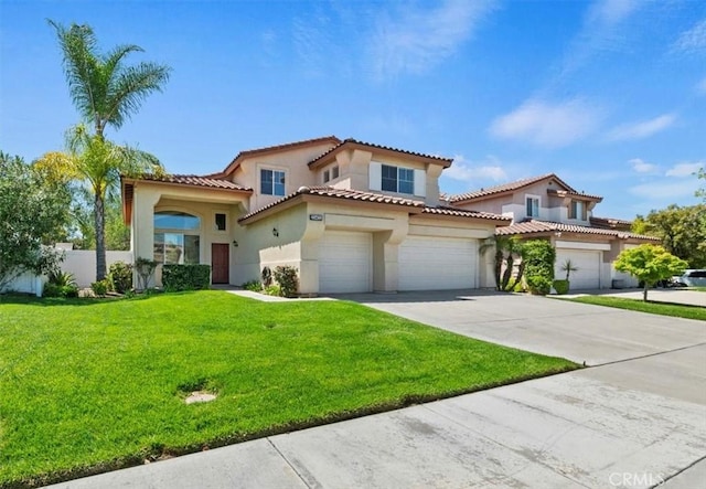 23403 Mountain Song, Murrieta, CA 92562 - mediterranean / spanish-style home with stucco siding, driveway, a front yard, a tile roof, and a garage