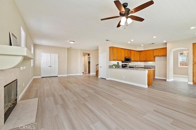 23403 Mountain Song, Murrieta, CA 92562 - unfurnished living room featuring arched walkways, recessed lighting, light wood finished floors, and a ceiling fan