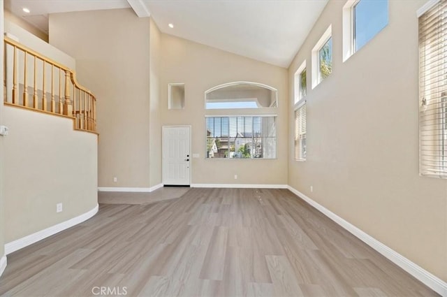 23403 Mountain Song, Murrieta, CA 92562 - unfurnished living room featuring high vaulted ceiling, recessed lighting, baseboards, and wood finished floors