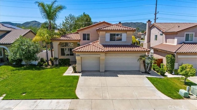 23403 Mountain Song, Murrieta, CA 92562 - mediterranean / spanish house featuring a front yard, a mountain view, a tiled roof, concrete driveway, and stucco siding
