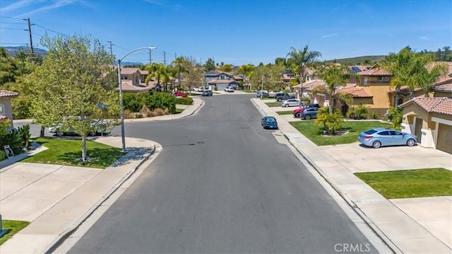 23403 Mountain Song, Murrieta, CA 92562 - view of street with sidewalks, curbs, a residential view, and street lighting