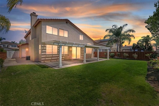 23403 Mountain Song, Murrieta, CA 92562 - back of property at dusk with a chimney, a pergola, a patio area, a fenced backyard, and a yard