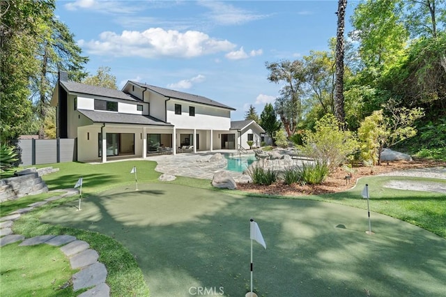 back of house with a patio area, an outdoor pool, stucco siding, and fence
