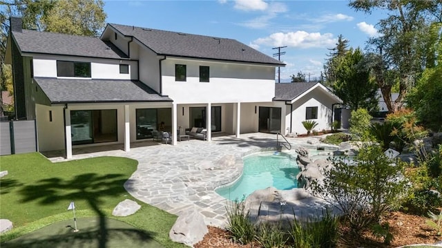 back of house with an outdoor living space, stucco siding, a lawn, a patio, and an outdoor pool