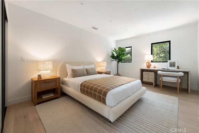 bedroom featuring light wood-style flooring and baseboards