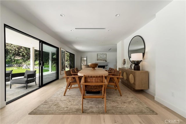 dining area featuring light wood-style flooring, baseboards, and recessed lighting