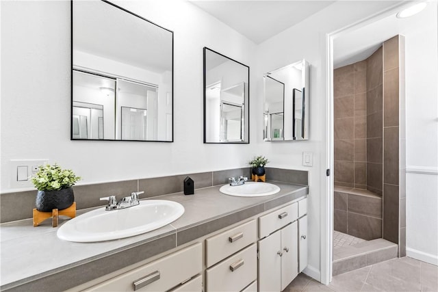 10022 Bismark Dr, Huntington Beach, CA 92646 - bathroom featuring double vanity, a sink, a tile shower, and tile patterned flooring