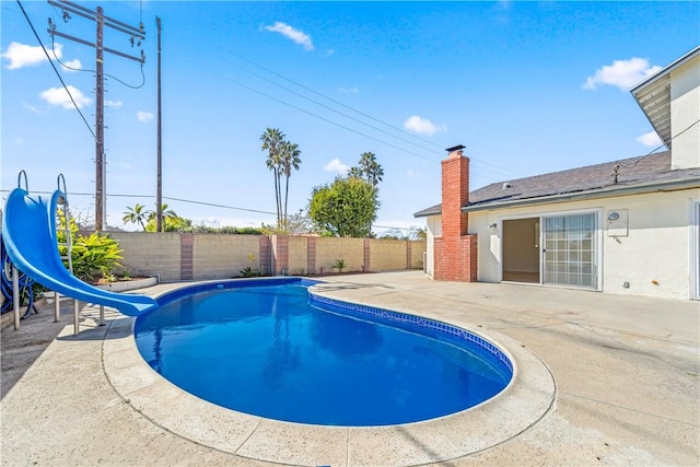 10022 Bismark Dr, Huntington Beach, CA 92646 - view of swimming pool featuring a fenced backyard, a water slide, a patio area, and a fenced in pool