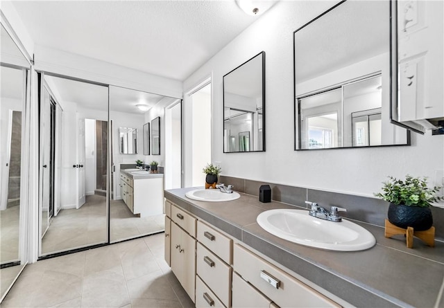10022 Bismark Dr, Huntington Beach, CA 92646 - bathroom with tile patterned floors, double vanity, and a sink