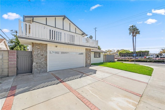 10022 Bismark Dr, Huntington Beach, CA 92646 - view of front of property featuring stone siding, concrete driveway, an attached garage, board and batten siding, and a balcony