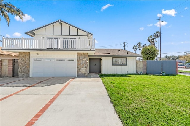 10022 Bismark Dr, Huntington Beach, CA 92646 - view of front facade featuring stone siding, a front yard, a balcony, and concrete driveway