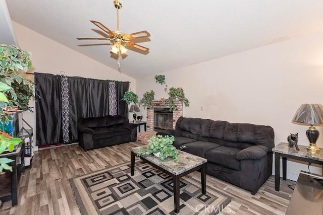 living room featuring vaulted ceiling, light wood-style floors, and a ceiling fan
