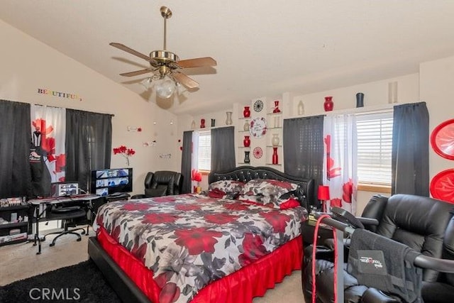 carpeted bedroom featuring a ceiling fan and vaulted ceiling