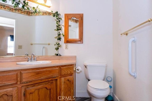 bathroom featuring toilet and vanity