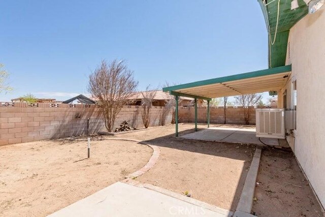 view of yard featuring a patio, central air condition unit, and a fenced backyard