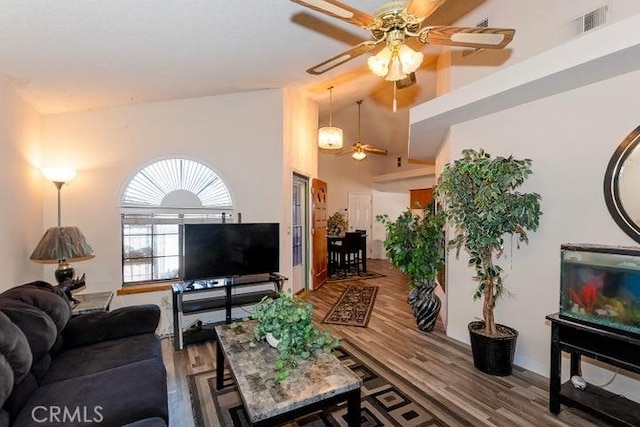 living room featuring high vaulted ceiling, ceiling fan, wood finished floors, and visible vents