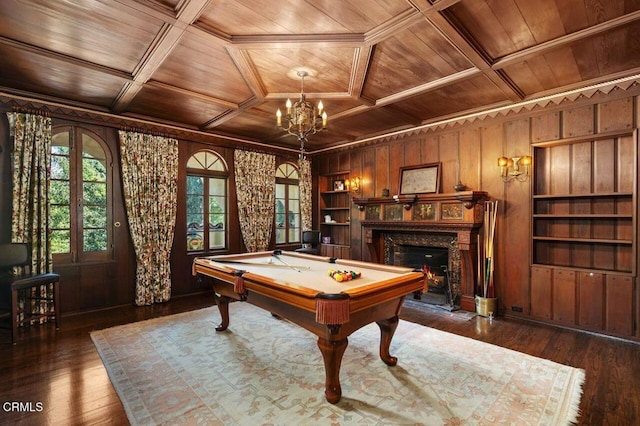 game room with built in features, wooden walls, billiards, wood ceiling, and a premium fireplace