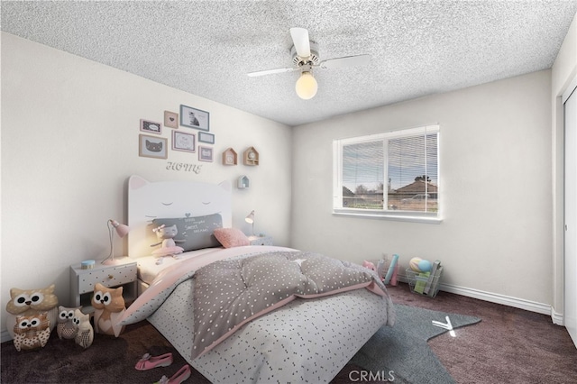 bedroom featuring carpet floors, baseboards, ceiling fan, and a textured ceiling