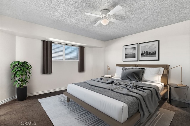 bedroom featuring a ceiling fan, carpet floors, baseboards, and a textured ceiling