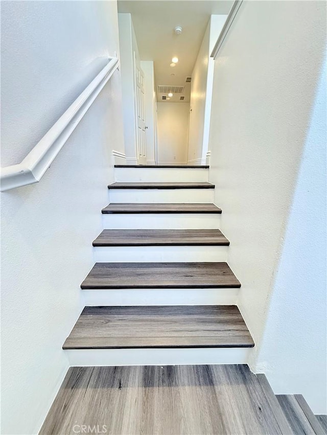 staircase featuring wood finished floors
