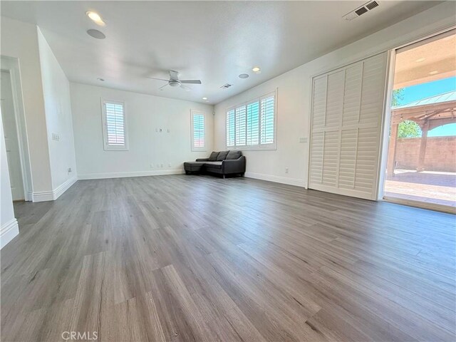 unfurnished living room with recessed lighting, wood finished floors, baseboards, visible vents, and a ceiling fan