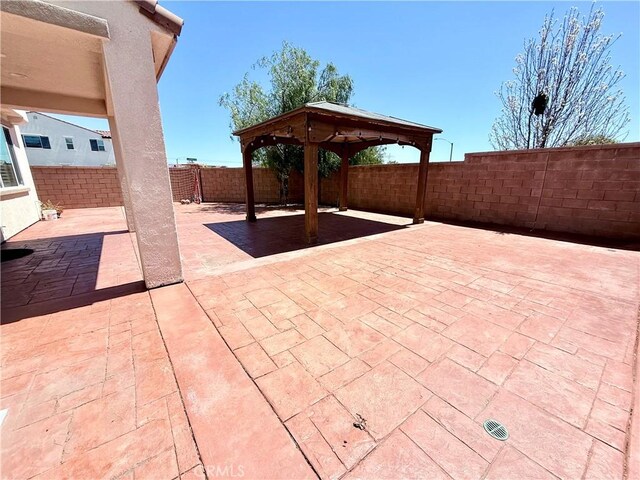 view of patio featuring a gazebo and a fenced backyard
