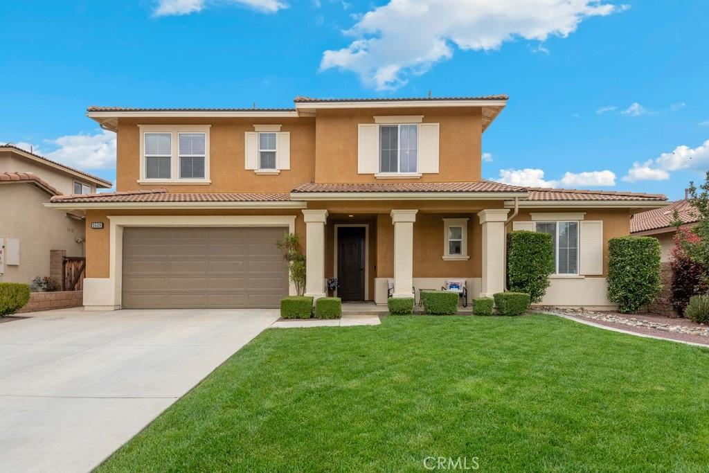 28428 Fox Rdg, Menifee, CA 92585 - view of front of house with stucco siding, a garage, a tile roof, driveway, and a front lawn