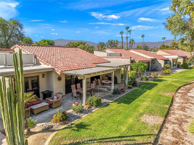 40310 Bay Hill Way, Palm Desert, CA 92211 - rear view of property featuring a lawn, a tiled roof, a patio, and a mountain view