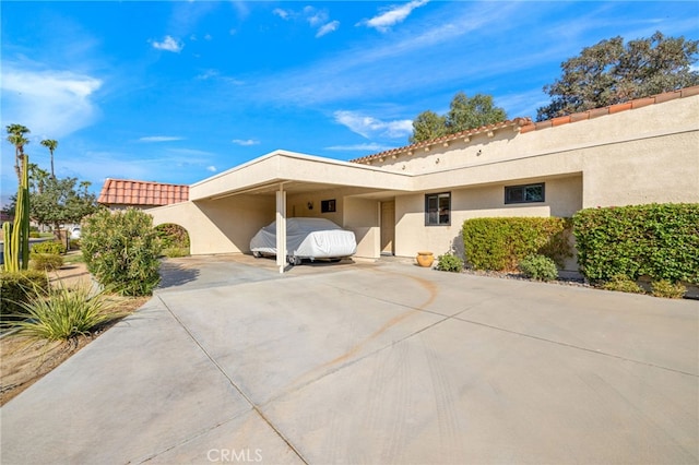 40310 Bay Hill Way, Palm Desert, CA 92211 - view of home's exterior featuring driveway, stucco siding, and a carport