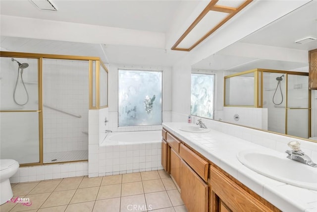 bathroom with a garden tub, a sink, a stall shower, and tile patterned flooring