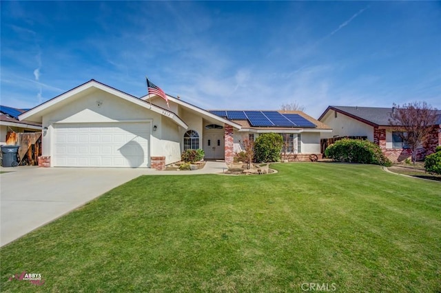 single story home with concrete driveway, stucco siding, an attached garage, a front lawn, and solar panels