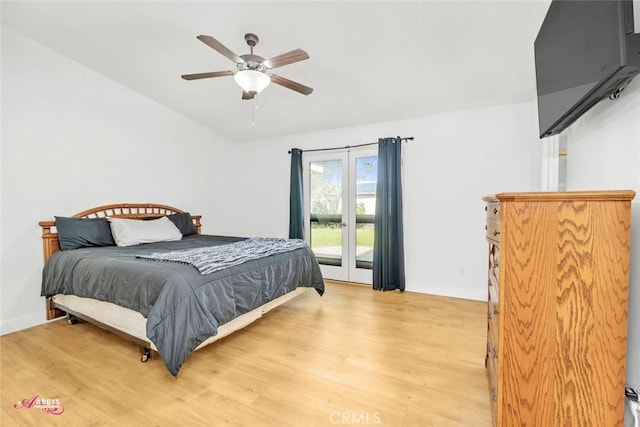 bedroom with light wood-style floors, baseboards, and access to outside