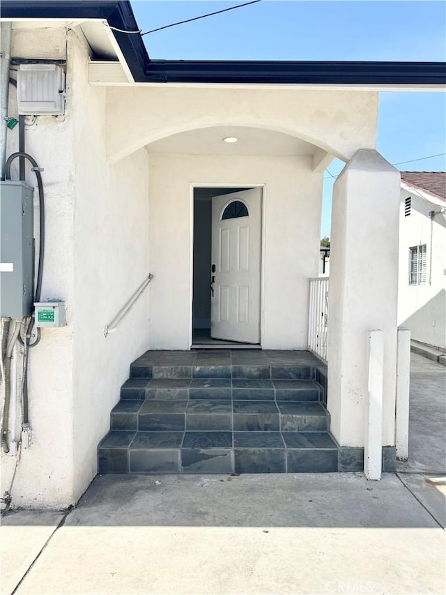 doorway to property with stucco siding